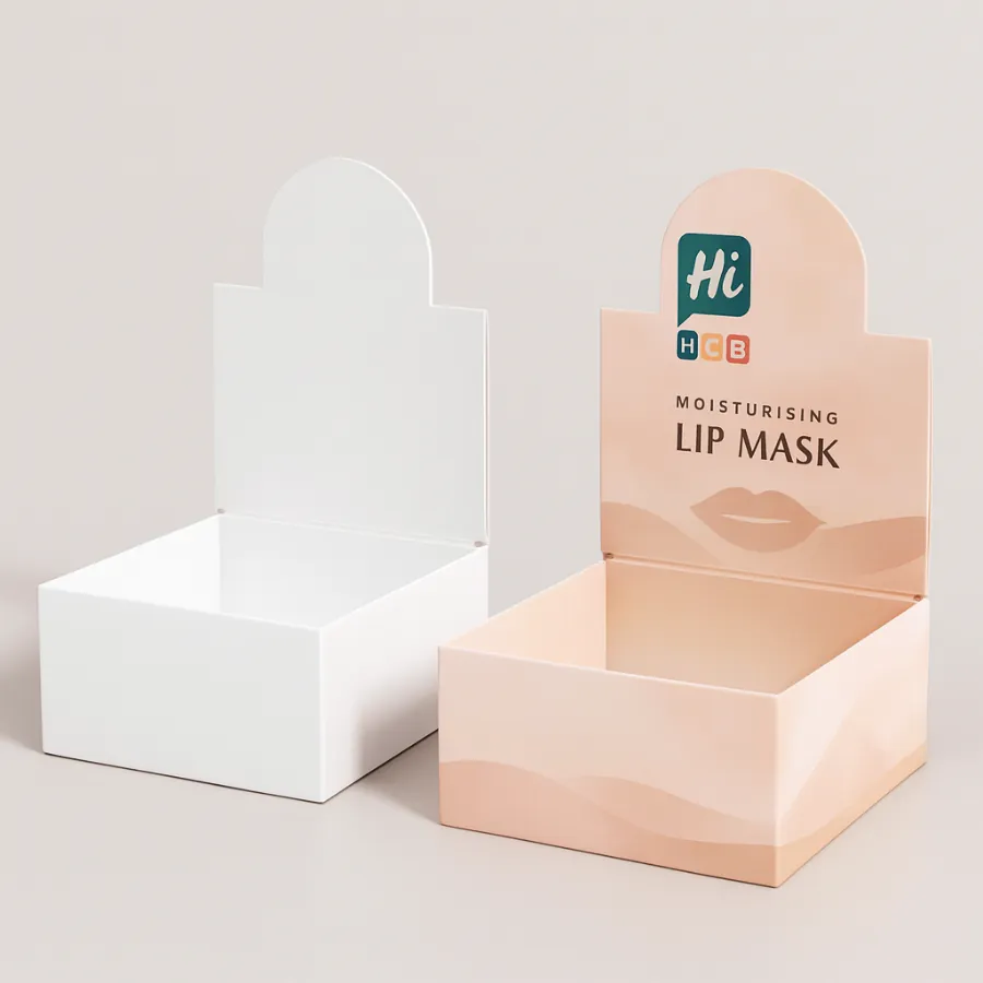 Two open-top cardboard display trays- one white and one with peach -HCB- branding- class=